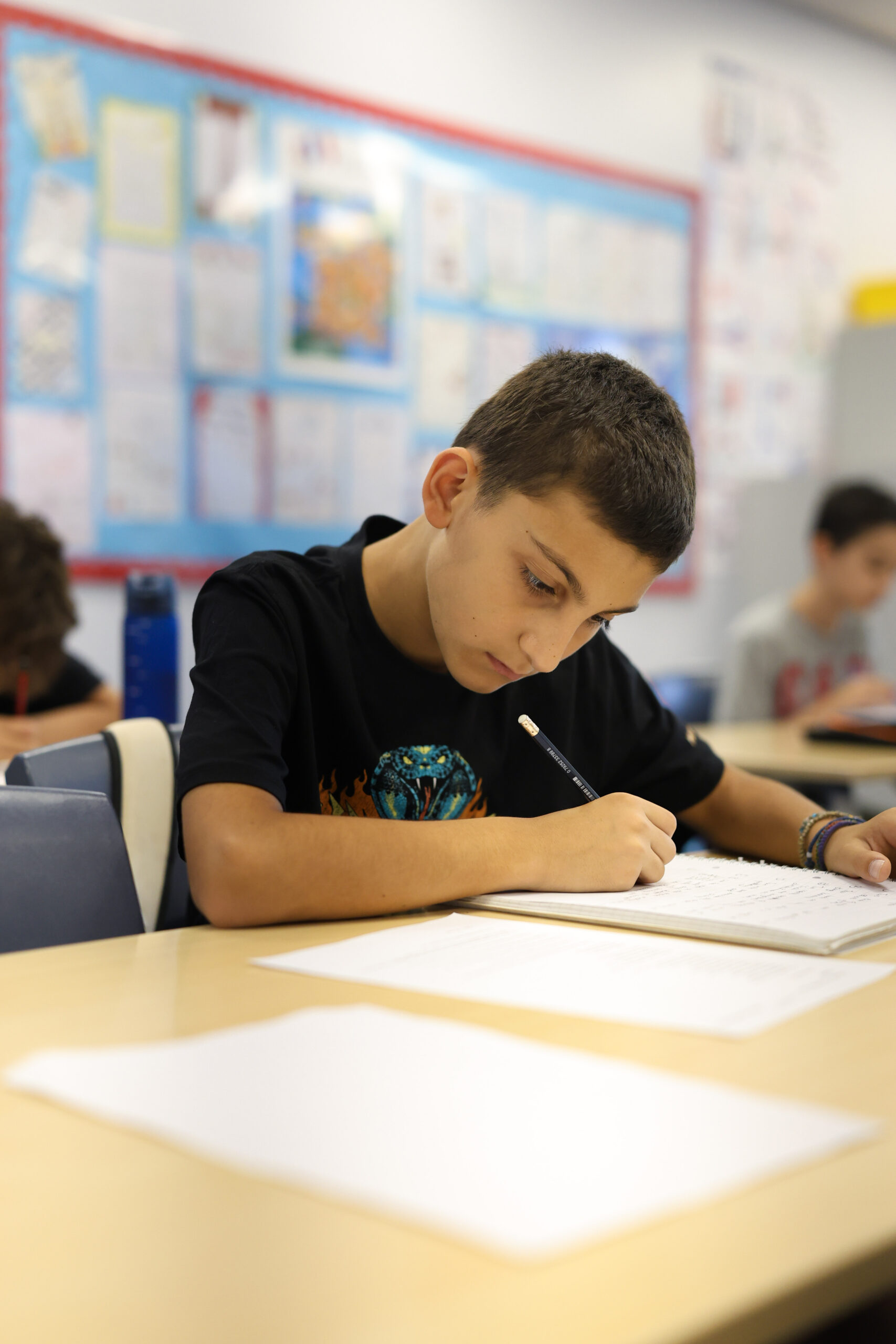Child writing at a desk